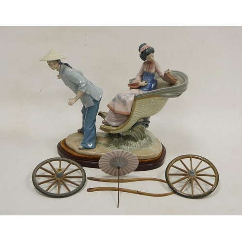 14 - Lladro group of a Chinese girl in carriage, printed marks, the girl seated in a basket moulded carri... 