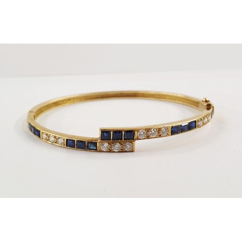 239 - 18ct gold, sapphire and diamond bangle, fine crossover pattern and set with 14 square-cut sapphires ... 