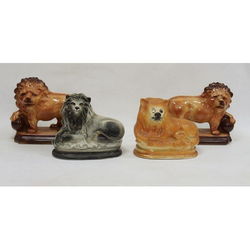 32 - Collection of Staffordshire pottery models of lions, early 20th century, comprising a pair of Hanley... 