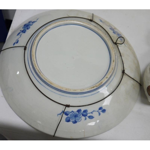 40 - Asian porcelain blue and white charger printed with a bird perched on trellis before chinoiserie flo... 