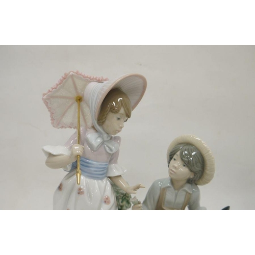 64 - Two Lladro figures, printed impress marks, the first modelled as a girl pushing a wheelbarrow with t... 