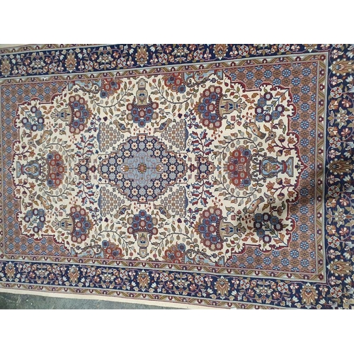 1018 - Persian style ivory rug with central lozenge medallions surrounded by floral and stylised animal des... 