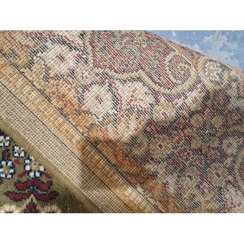 1040 - Modern Persian-style green ground rug with foliate decoration, approx. 350cm x 270cm