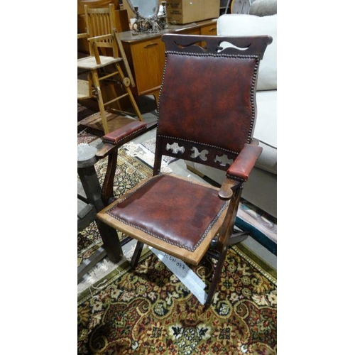 1142 - Folding chair with red leather upholstered back, seat and arms