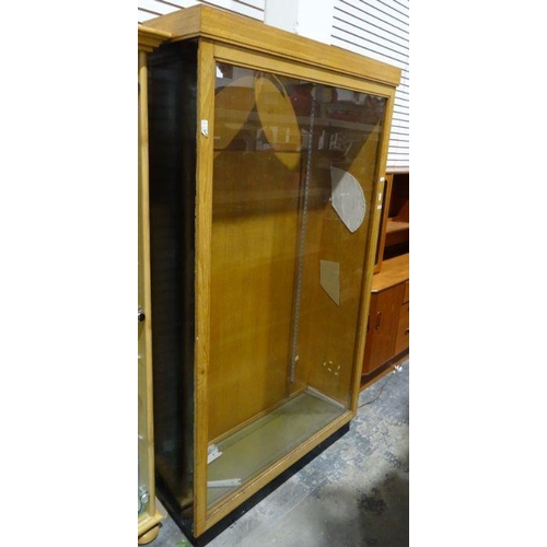 1151 - Oak and glazed shop display cabinet on plinth base, 112cm x 193cm