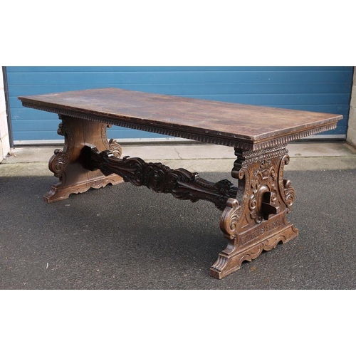 1173 - 17th/18th century Italian walnut trestle table, the rectangular top on carved and shaped end support... 