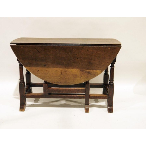 1183 - 17th century-style oak gateleg table on turned and block supports, stretchered base, 110cm wide