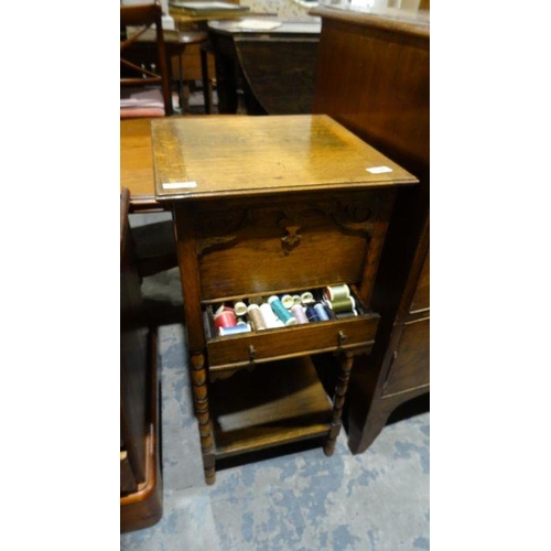 1197 - 20th century oak sewing table on bobbin turned supports, and contents to include silk sewing bobbins... 