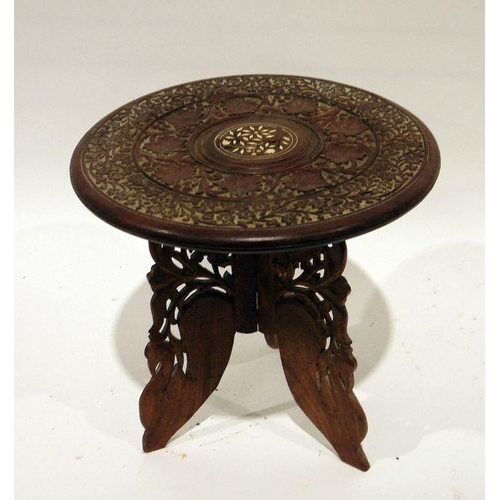 1199 - Eastern carved coffee table with bone inlay and folding carved base, 38cm diameter