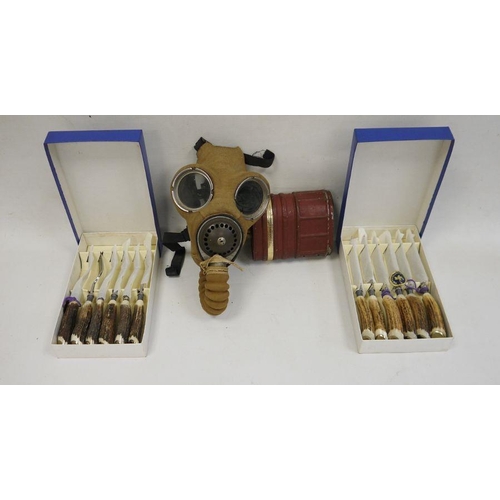 170 - WWII gas mask and a set of knives and forks with antler handles