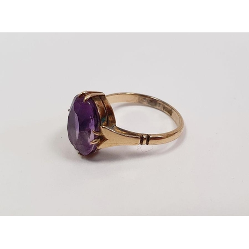 338 - 9ct gold and amethyst solitaire ring set oval facet-cut stone