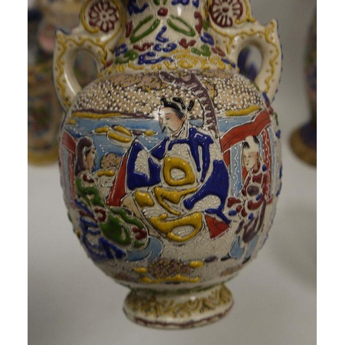 52 - A collection of Japanese pottery vases, early 20th century, each decorated in raised enamels with fi... 