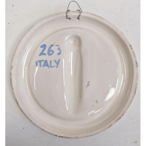 49 - Della Robbia pottery arched shaped plaque, the Annunciation, with fluting border, 32cm wide, similar... 