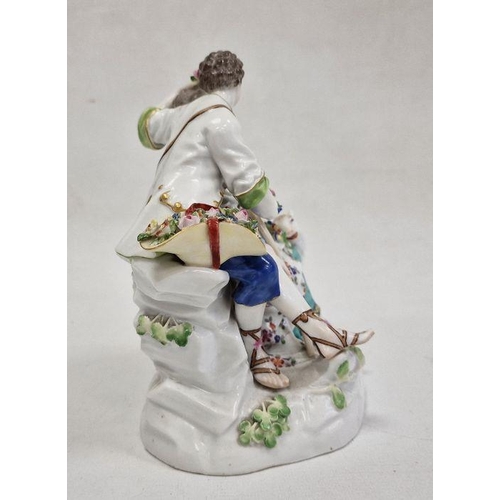 54 - 19th century Meissen porcelain figure group of shepherd and shepherdess seated on rocky mound, the g... 