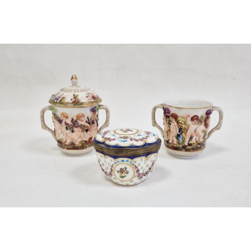 61 - Pair Capodimonte porcelain covered two-handled chocolate cups, relief decorated with Bacchanalian ch... 