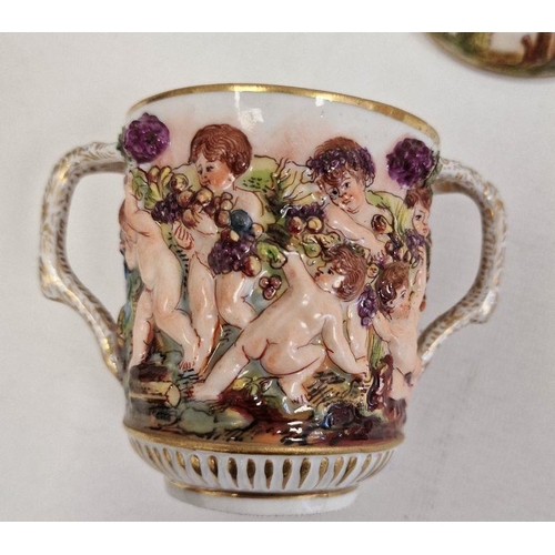 61 - Pair Capodimonte porcelain covered two-handled chocolate cups, relief decorated with Bacchanalian ch... 