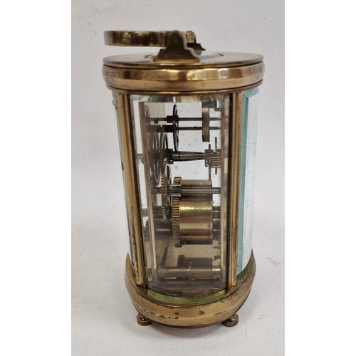 1012 - 20th century brass and glass carriage clock with oval body, Roman numerals to the dial, 11cm high