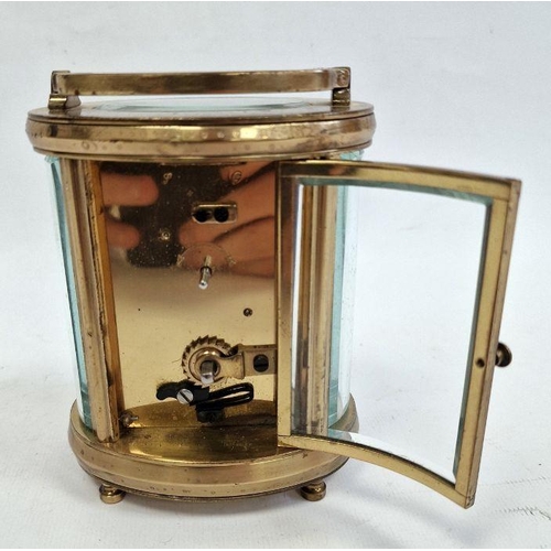 1012 - 20th century brass and glass carriage clock with oval body, Roman numerals to the dial, 11cm high