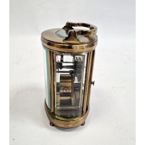 1012 - 20th century brass and glass carriage clock with oval body, Roman numerals to the dial, 11cm high