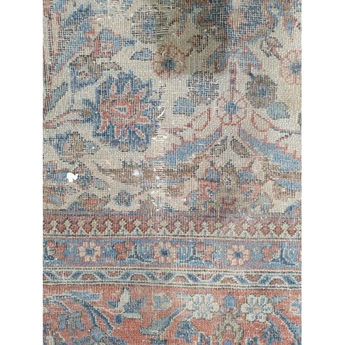 1033 - Persian herati-type rug, the cream ground with allover foliate decoration to the central field, on a... 