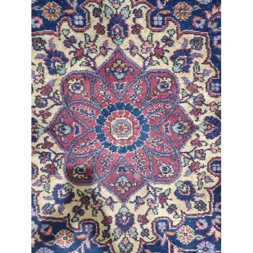 1038 - Persian-style carpet having shaped oval floral central medallion to the maroon ground, cream spandre... 