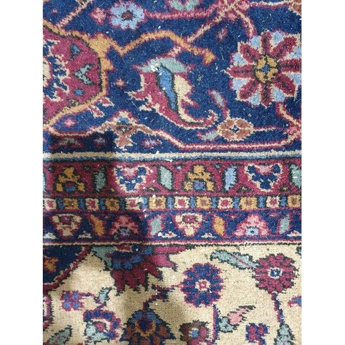 1038 - Persian-style carpet having shaped oval floral central medallion to the maroon ground, cream spandre... 