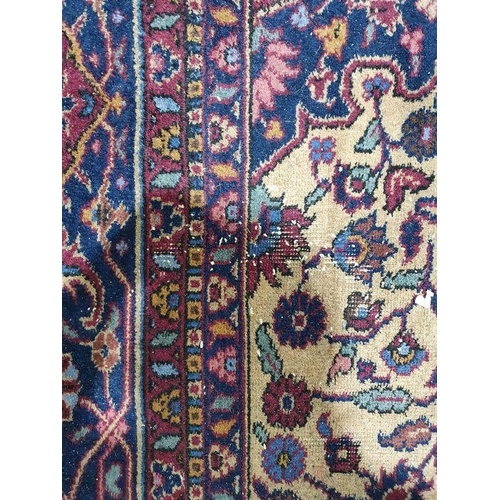 1038 - Persian-style carpet having shaped oval floral central medallion to the maroon ground, cream spandre... 