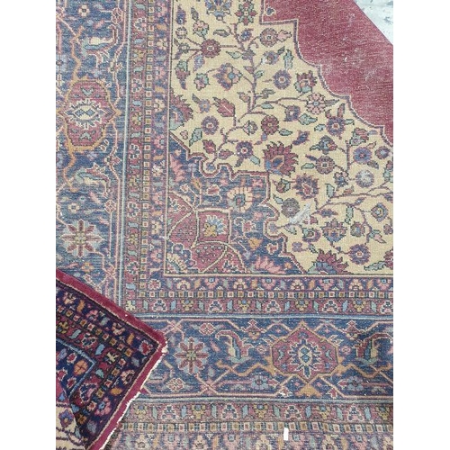 1038 - Persian-style carpet having shaped oval floral central medallion to the maroon ground, cream spandre... 