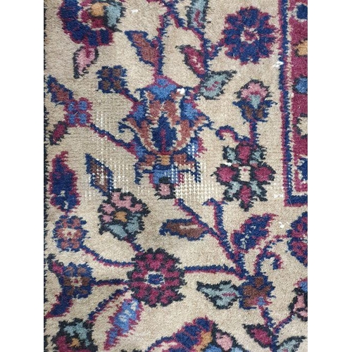 1038 - Persian-style carpet having shaped oval floral central medallion to the maroon ground, cream spandre... 