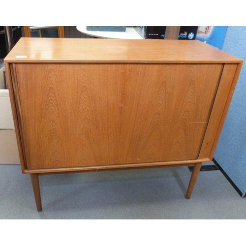 1054 - Mid century modern teak cabinet, the rectangular top above tambour door, on cylindrical tapering sup... 