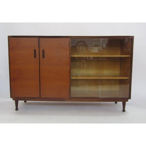 1058 - Meredew teak bookcase with two cupboard doors and glass doors encasing shelves, turned supports, 83.... 