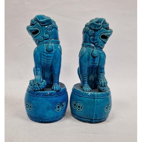 123 - Pair Chinese turquoise glazed Buddhist lions each on a circular drum base, 20cm high