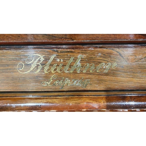 1257 - Bluthner rosewood upright pianoforte, iron-framed and overstrung, no.56725 with brass hinged candle ... 