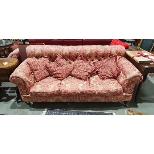 1383 - Victorian button-back Chesterfield three-seater settee in pink floral brocade and on turned bun feet... 