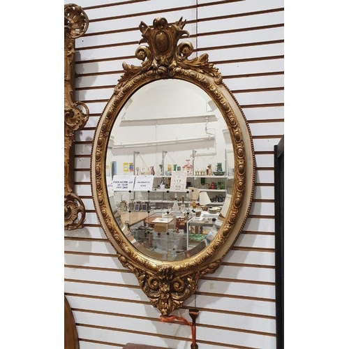 1398 - Oval bevel edged mirror in moulded egg and dart frame, 94cm x 55cm