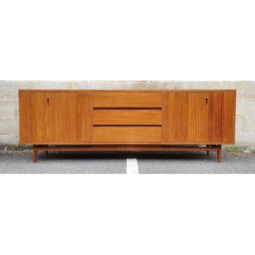 1409 - Mid century modern teak sideboard with three central drawers flanked by folding cupboard doors, on t... 