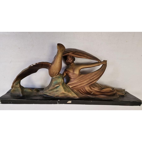 18 - Art Deco large bronzed-effect plaster figure of girl reclining the side with eagle on rock, on black... 