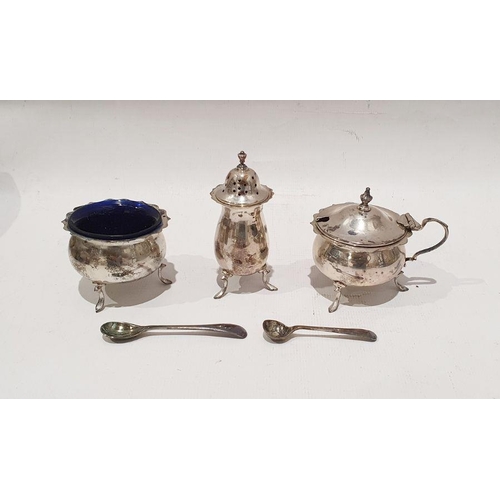 253 - Silver three-piece cruet, all with serpentine rim and blue glass liner, Birmingham 1931, cased