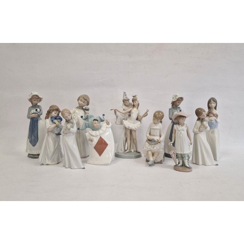 29 - Lladro figure group ballerina and clown, two Nao girls with puppies, Nao girl seated with blackboard... 