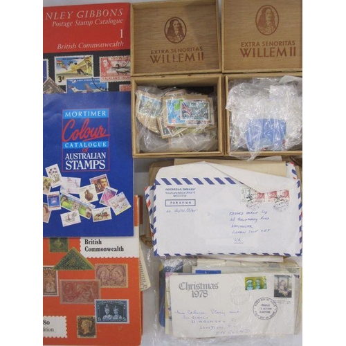 224 - Bag and box of 100s of used stamps and Australian year books, from 1980's and 1990's plus three cata... 