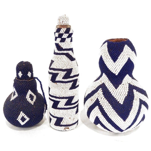 199 - Two African beaded gourds and beaded bottle, featuring blue and white ziz-zag and diamond patterns.