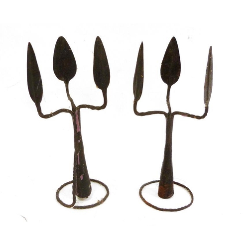 217 - Pair of African metalwares, in the form of a triple-headed spearhead, featuring sections of ornament... 