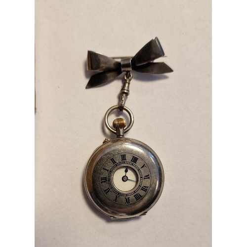 439 - Lady’s silver half-hunter fob watch with black enamel Roman numerals and bow-pattern suspender