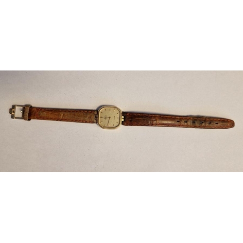 461 - Lady's rolled gold-cased Omega wristwatch, the champagne square dial with hour batons, on a leather ... 