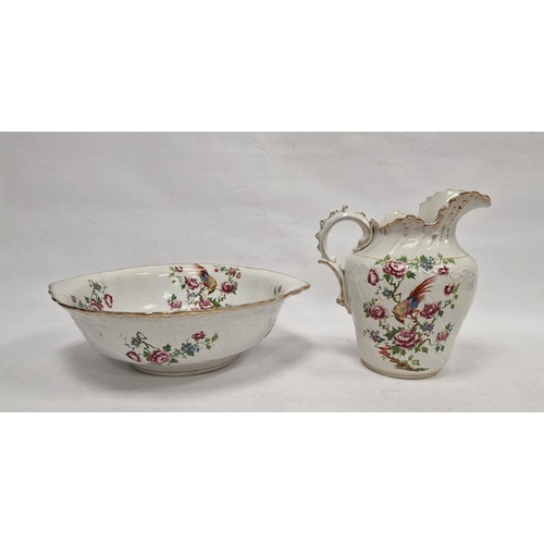 51 - Staffordshire pottery ewer and basin decorated with exotic bird and rose branches