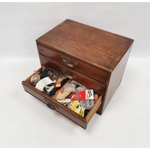 121 - Oak table-top nest of four drawers containing assorted sewing items, to include ribbons, reels of co... 