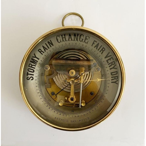 246 - Edwardian gilt brass cased aneroid skeleton barometer, with glass front, blued steel and gilt metal ... 