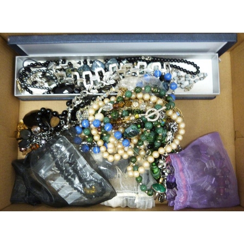 374 - Two boxes of assorted costume jewellery to include rings, pendants, bangles, necklaces, brooches, et... 