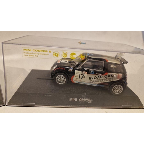 535 - Four cased Scalextric slot cars to include Mini Cooper S Marked 17A, Mini Cooper S marked 1, Aston M... 