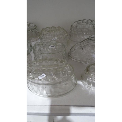 57 - Collection of twenty-one glass press-moulded jelly moulds, in various designs including a rabbit, 21... 